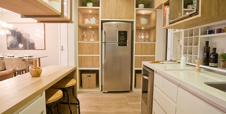 Uma fotografia de uma cozinha americana com móveis planejados. 